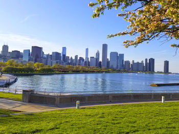 Scenic view of river by buildings against sky
