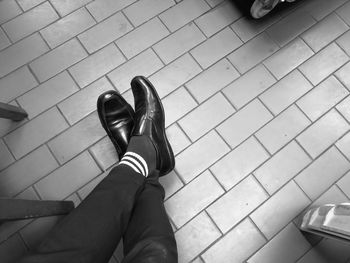 Low section of man on tiled floor