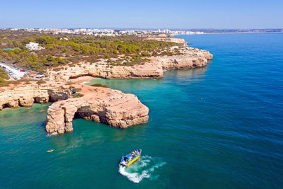 High angle view of rocks in sea against sky