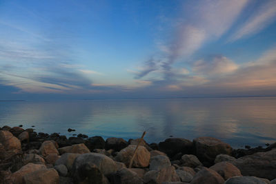 Scenic view of calm sea against cloudy sky