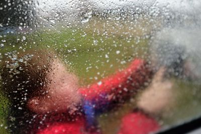 Close-up of hand on glass window