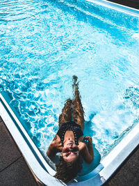 High angle view of young man swimming in pool