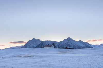 Scenic view of snowcapped mountains against sky during sunset