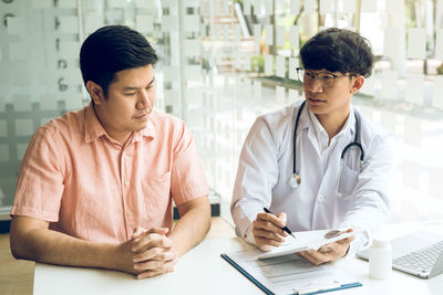 Doctor examining patient in office