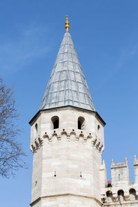 Low angle view of bell tower against blue sky