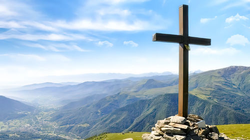 Scenic view of mountains against sky and the origins of summit crosses