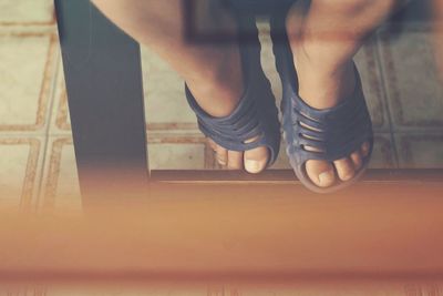 Low section of woman standing on floor