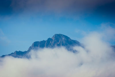 Low angle view of mountains against blue sky