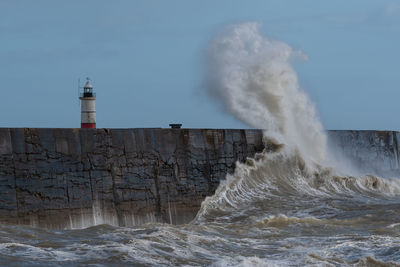 Waves crashing against a sea defence harbour wall at newhaven in east sussex