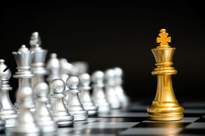 Close-up of chess pieces against black background