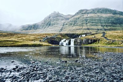 Scenic view of lake and mountains against sky