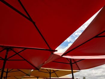 Low angle view of red umbrella against sky