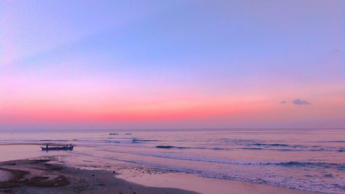 Scenic view of beach against sky during sunset