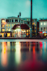 Reflection of illuminated buildings in city at night