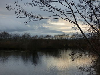 Scenic view of lake against sky at sunset