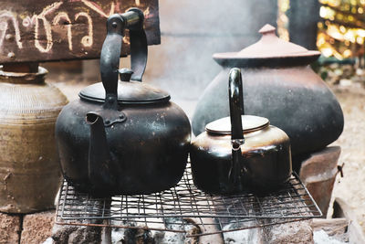 Old kettle with smoke in camping outdoor