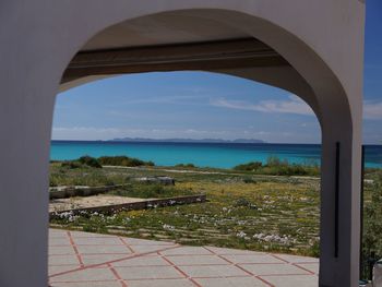 Scenic view of sea seen through arch