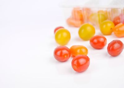 Close-up of multi colored candies against white background