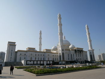 Buildings in city against clear sky