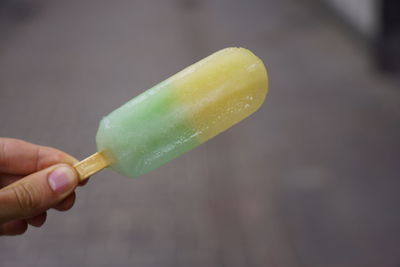 Close-up of hand holding ice cream