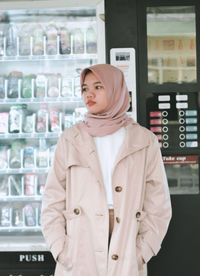 Portrait of young woman standing in store