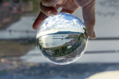 Close-up of hand holding crystal ball