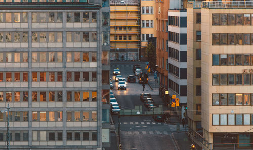 High angle view of cars on street amidst buildings in city