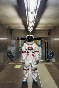 Male astronaut standing in basement