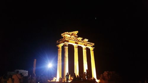 Low angle view of illuminated building against sky at night