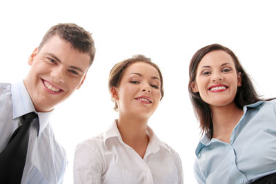 Portrait of smiling young couple against white background