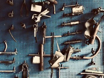 Close-up of clothes hanging on metal against wall