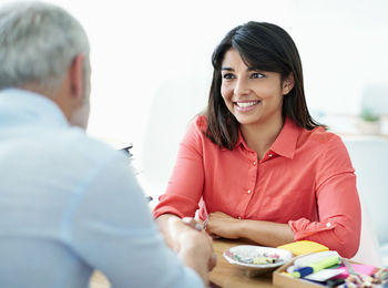 Portrait of smiling young woman using mobile phone