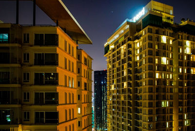 Low angle view of illuminated buildings at night