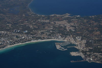 Aerial view of city by sea