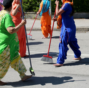 Rear view of people walking on footpath