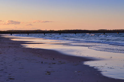 Scenic view of beach against sky during sunset