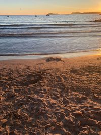 Scenic view of beach against sky during sunset