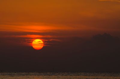 Scenic view of sea against orange sky