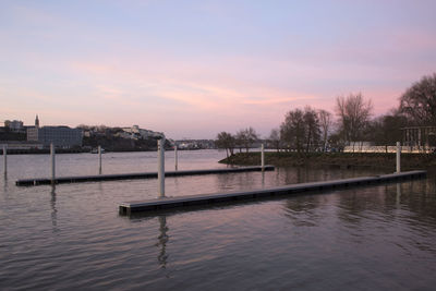 Scenic view of river against sky at sunset