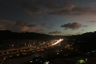 High angle view of illuminated buildings against sky at night