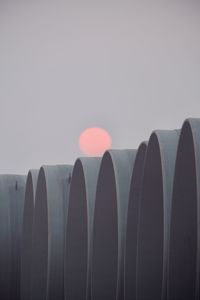 Close-up of pipes against sky during sunset