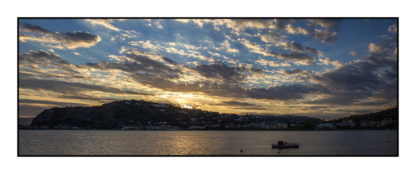 Scenic view of lake against cloudy sky