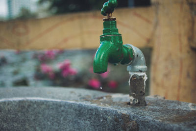 Close-up of faucet in glass container