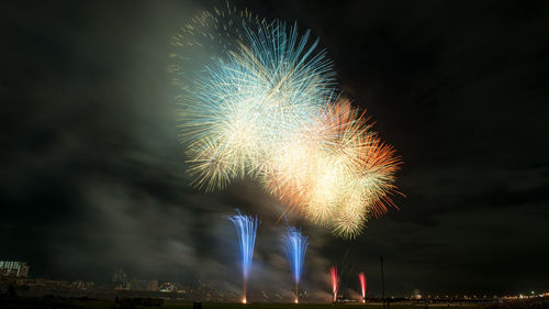 Low angle view of firework display at night