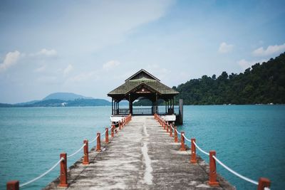 Pier over sea against sky