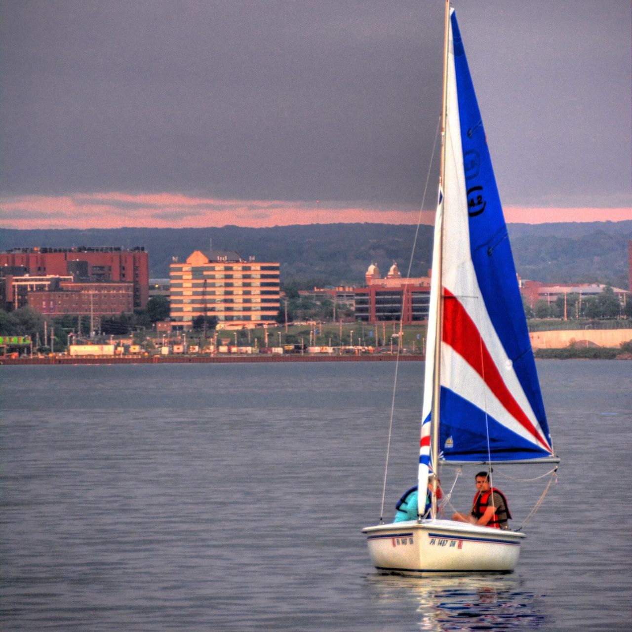 nautical vessel, flag, patriotism, transportation, water, waterfront, sea, national flag, identity, boat, mode of transport, american flag, sky, sailboat, sailing, culture, building exterior, travel, city, built structure