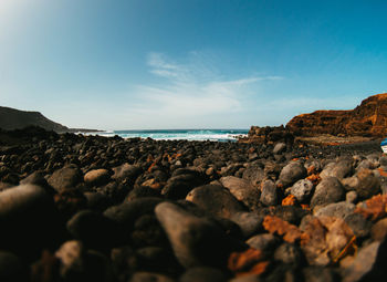 Rocks on shore against sky