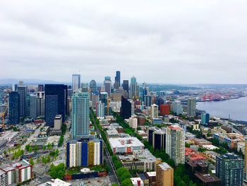 Aerial view of city against cloudy sky