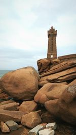 View of rocks against cloudy sky