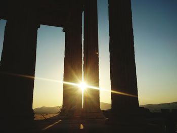 Silhouette built structure against sky during sunset